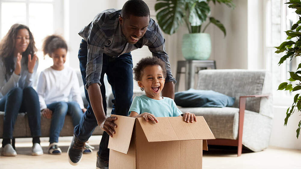 © AdobeStock/fizkes A family has fun in their new home