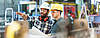Two international qualified workers talk at a metal fabrication plant.