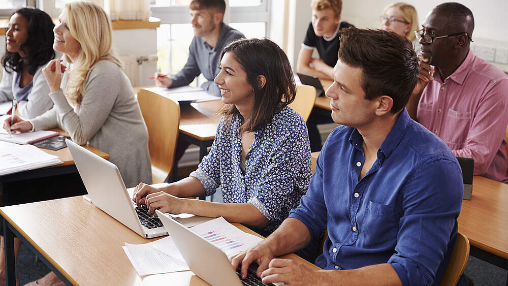 © Adobe Stock / Monkey business Mature students sitting in a classroom listening to a teacher