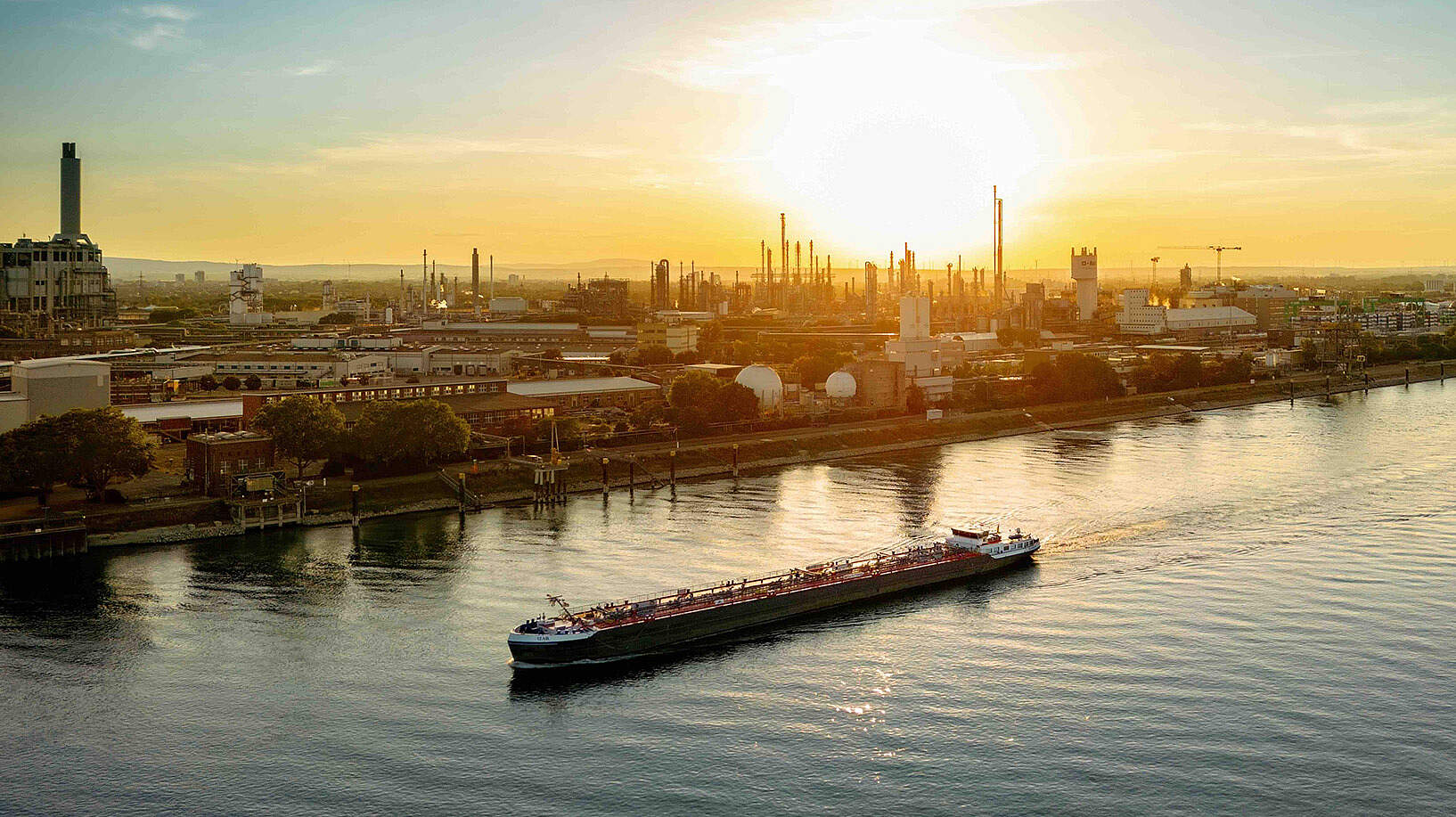 Aerial view of Ludwigshafen harbour with industrial facilities at sunset.